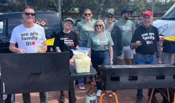 Photo of 4 men and 3 women having a World Aids Day sausage sizzle